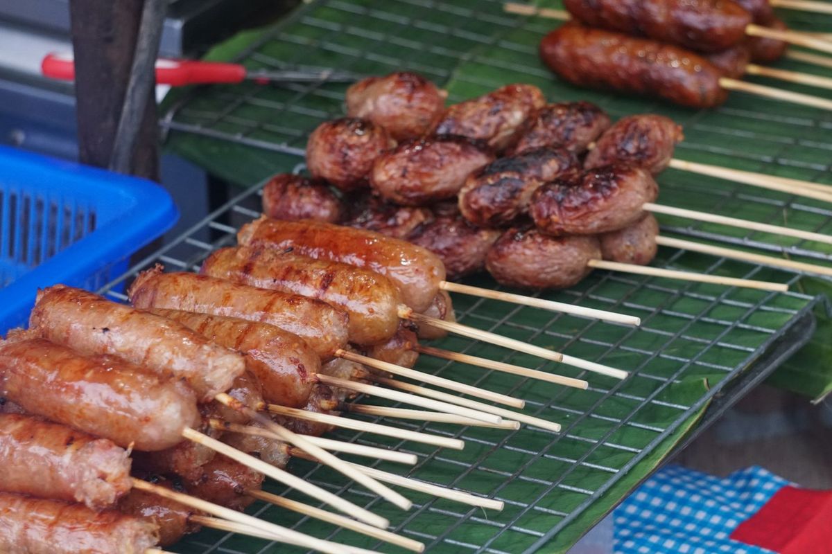 Grilled sausage skewers at a Chiang Mai night market stall.