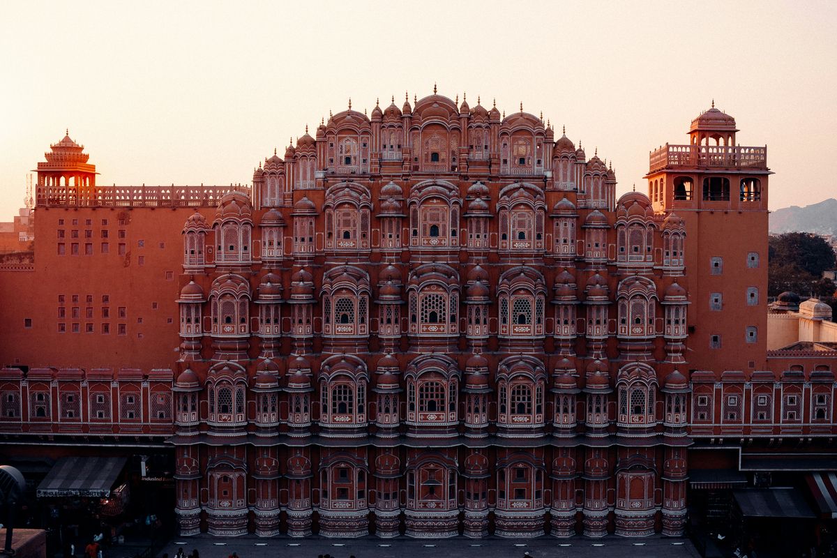 Hawa Mahal, the iconic five-story Palace of Winds in Jaipur, glowing warm at sunset.