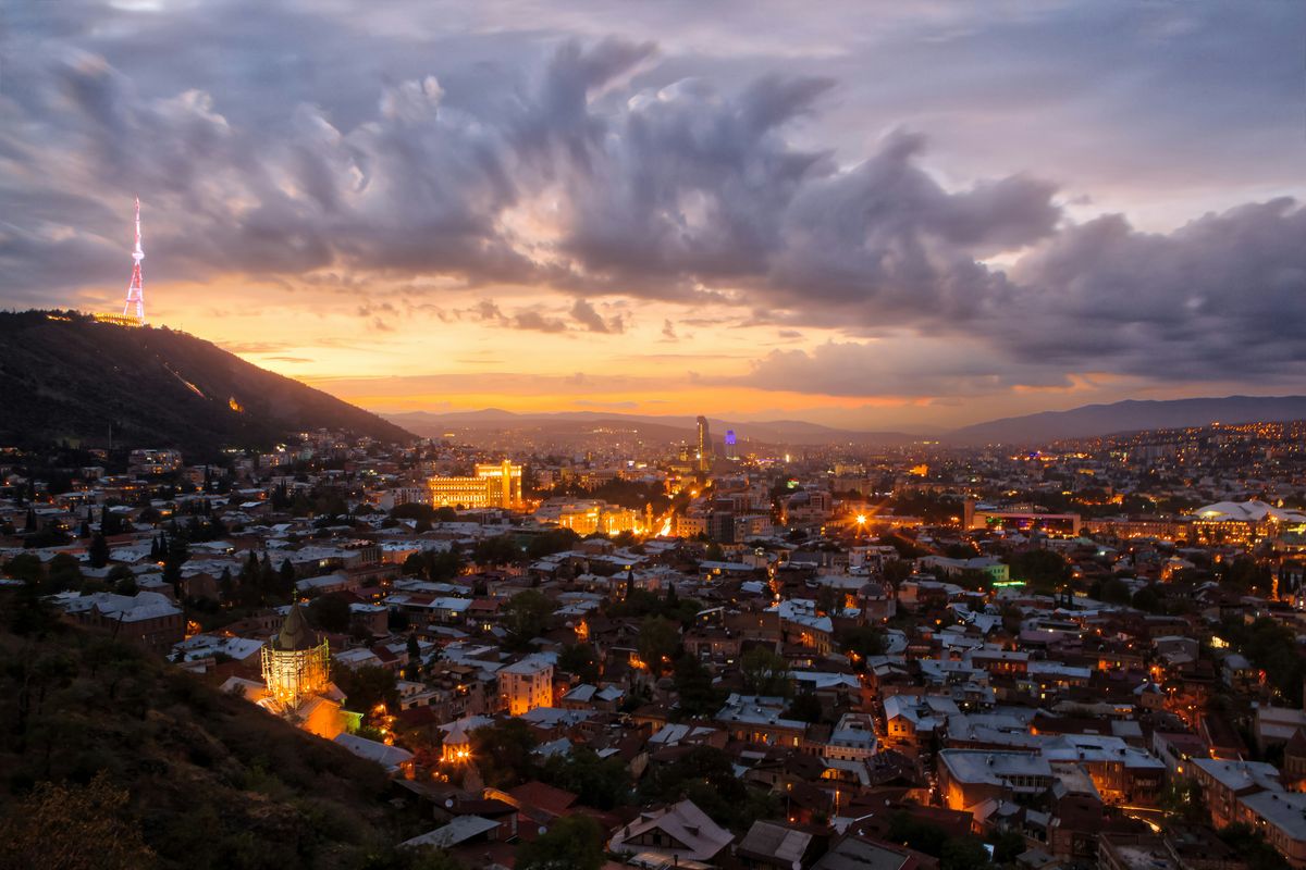 Tbilisi at dusk, with the TV tower and old town spread below