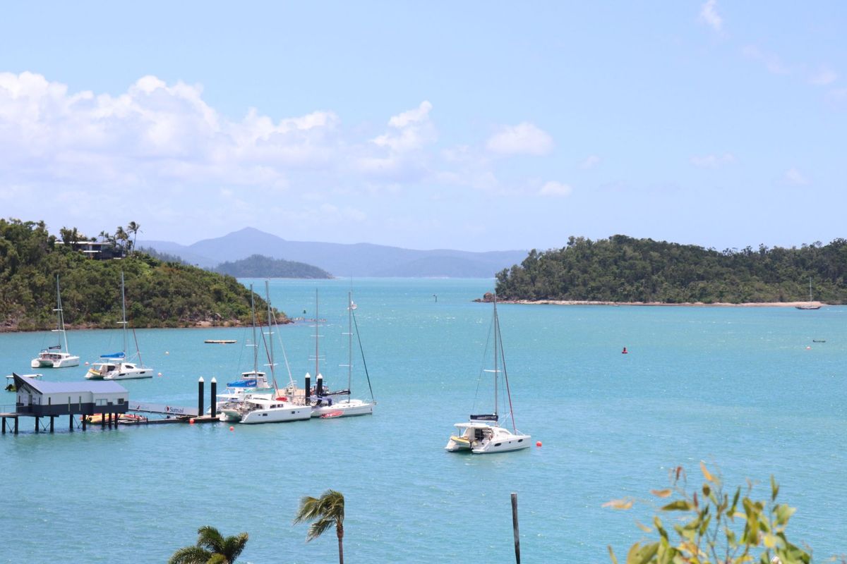 Sailboats anchored in the calm bay off Hamilton Island, Whitsundays